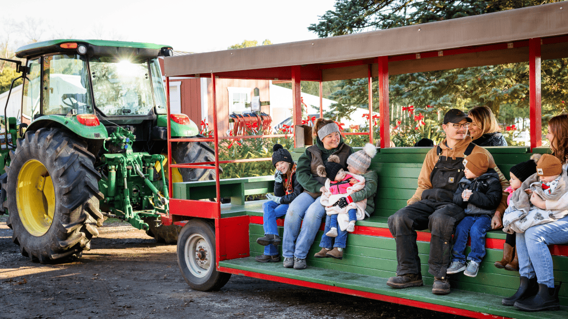 People boarding the tractor-pulled tram at Hensler Nursery. People boarding the tractor-pulled tram at Hensler Nursery.