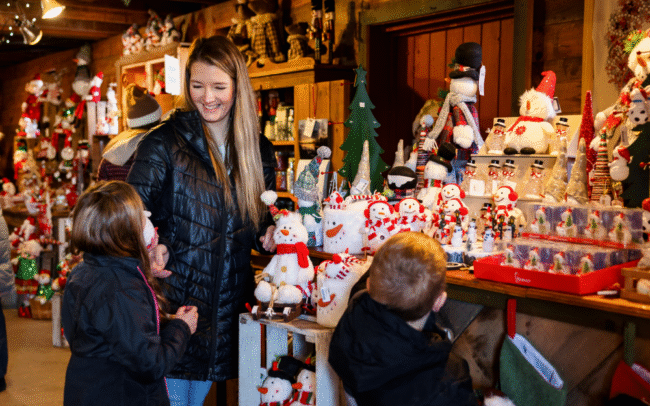 Mother and 3 children shopping in Hensler Nursery's Christmas Barn.